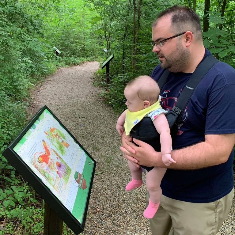 Read the story with little ones at stops along the wooded Storybook Trail 